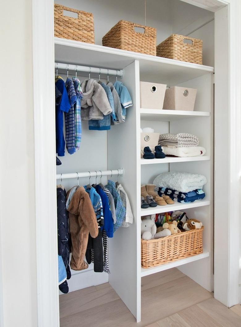 nursery organization in closet with custom shelving and double rods