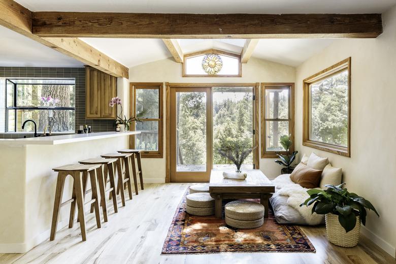 open concept living room with grounded sofa and wooden panels