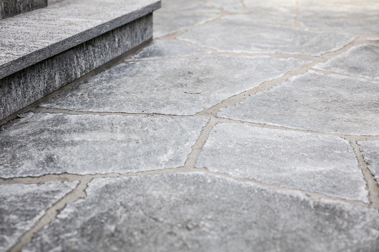 fresh builded stairs and grey flagstone floor with mortar joints