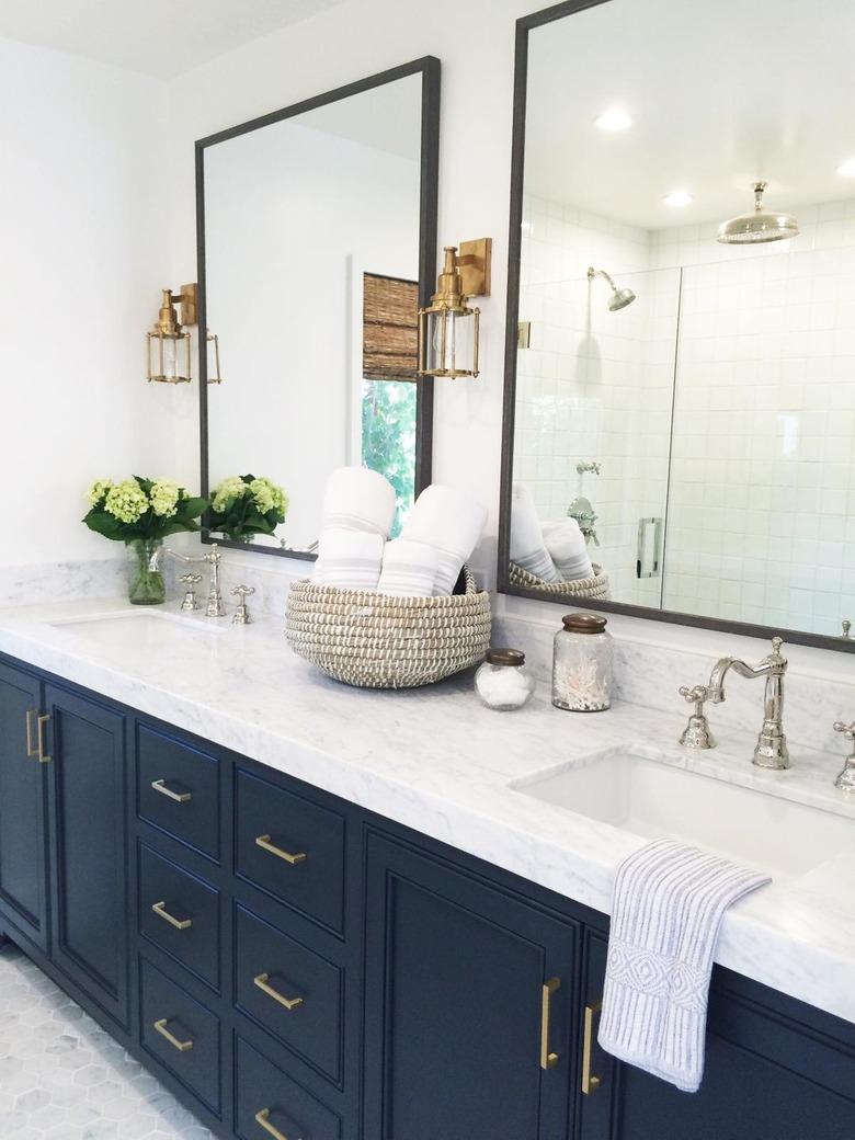 Bathroom with blue vanity and woven baket.