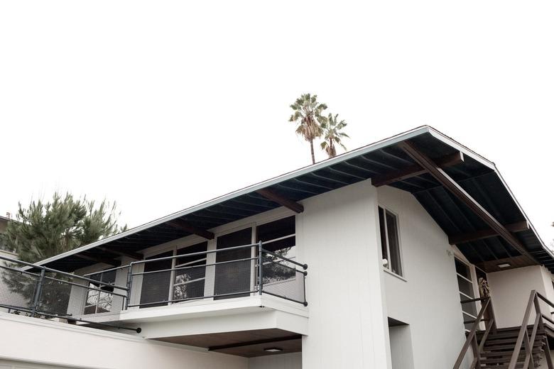 White modern home with large overhanging eaves and balcony