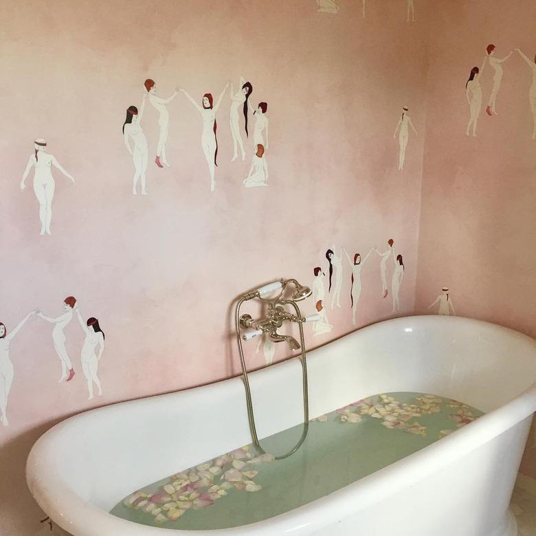 A bathroom with pink wallpaper