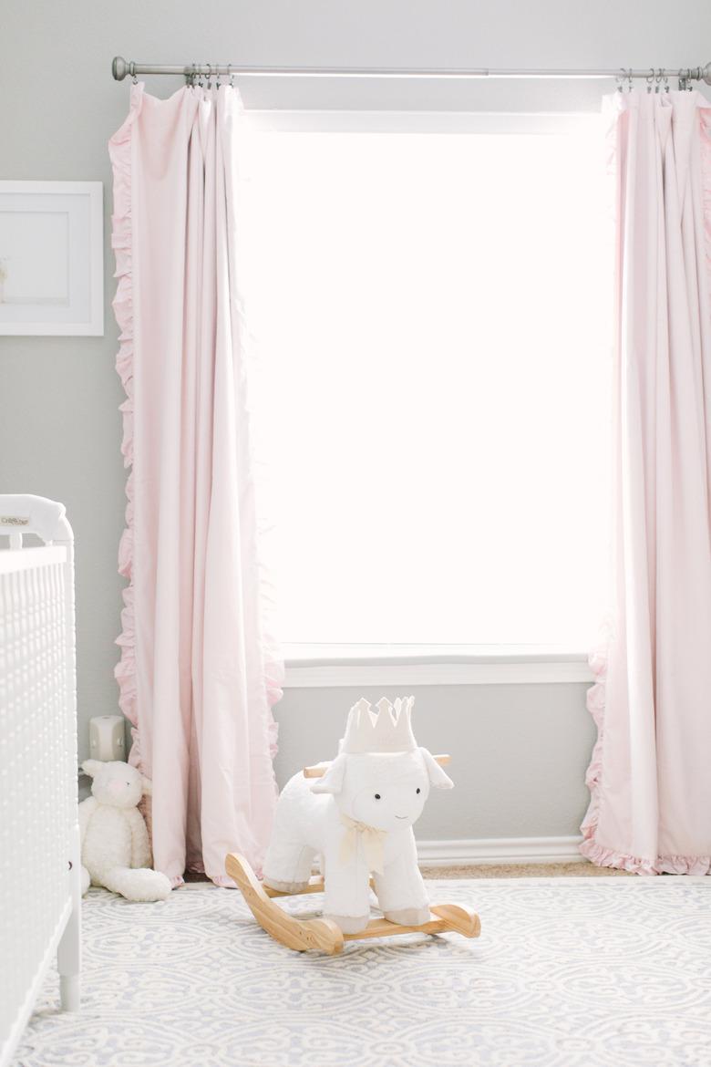 pretty pink and gray nursery idea with pink drapery and white crib