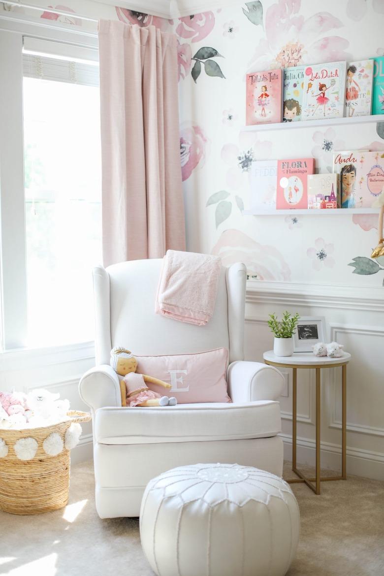 pink and white nursery idea with floral print wallpaper and pink drapery with white rocker