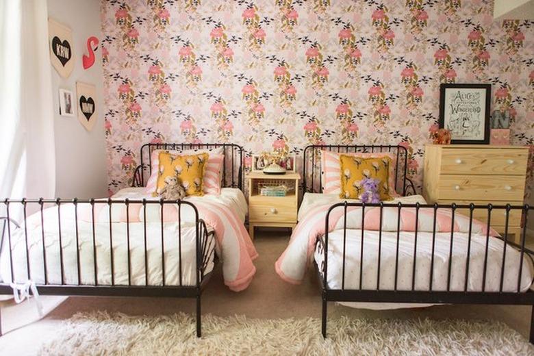 pink room ideas with Floral wallpaper, twin brass beds, multi-colored bedding.