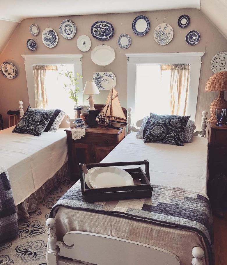 blue and white plates above windows and beds