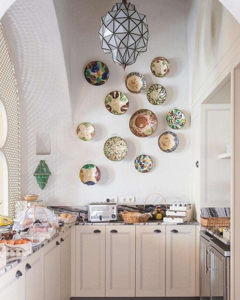 plates on kitchenette wall with high ceiling