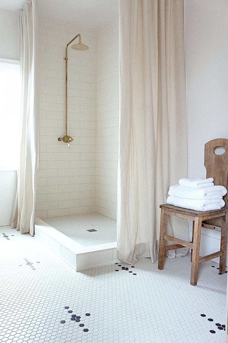 White bathroom with black and white mosaic bathroom floor tile