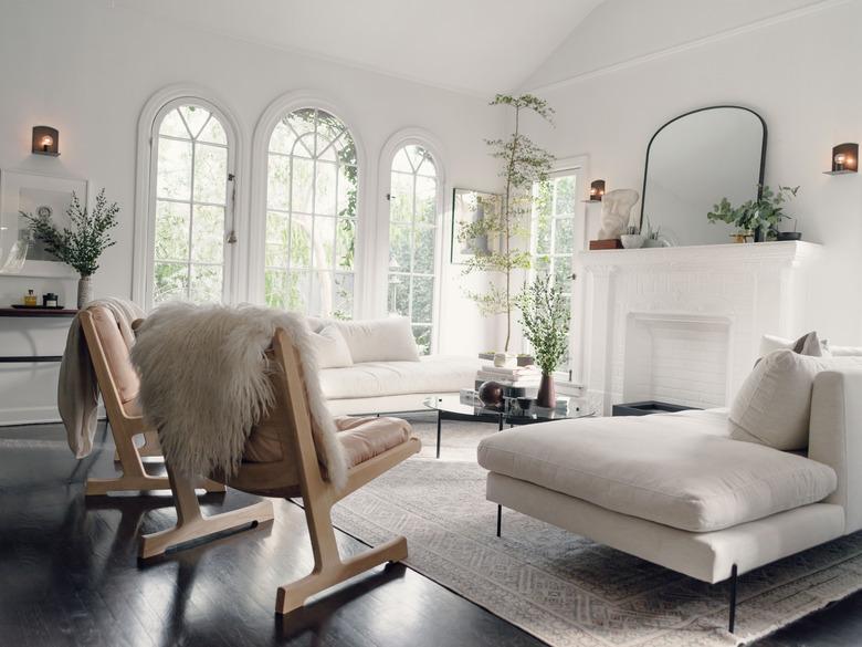 white Scandinavian fireplace in living room with wood flooring