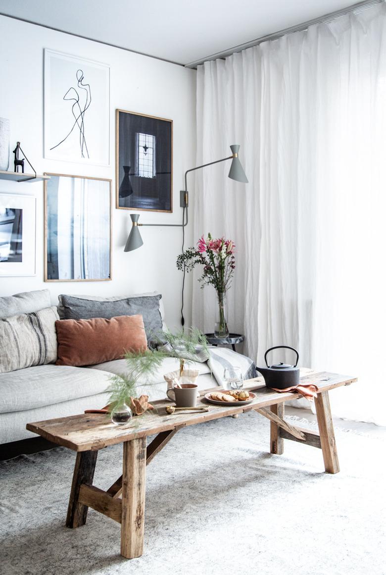 Statement floor lamp and gallery wall in Scandinavian living room