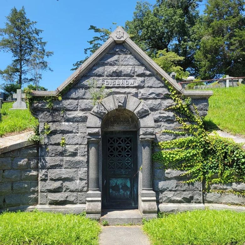 A grey, brick grave in Sleepy Hollow, NY in the Sleepy Hollow cemetary.