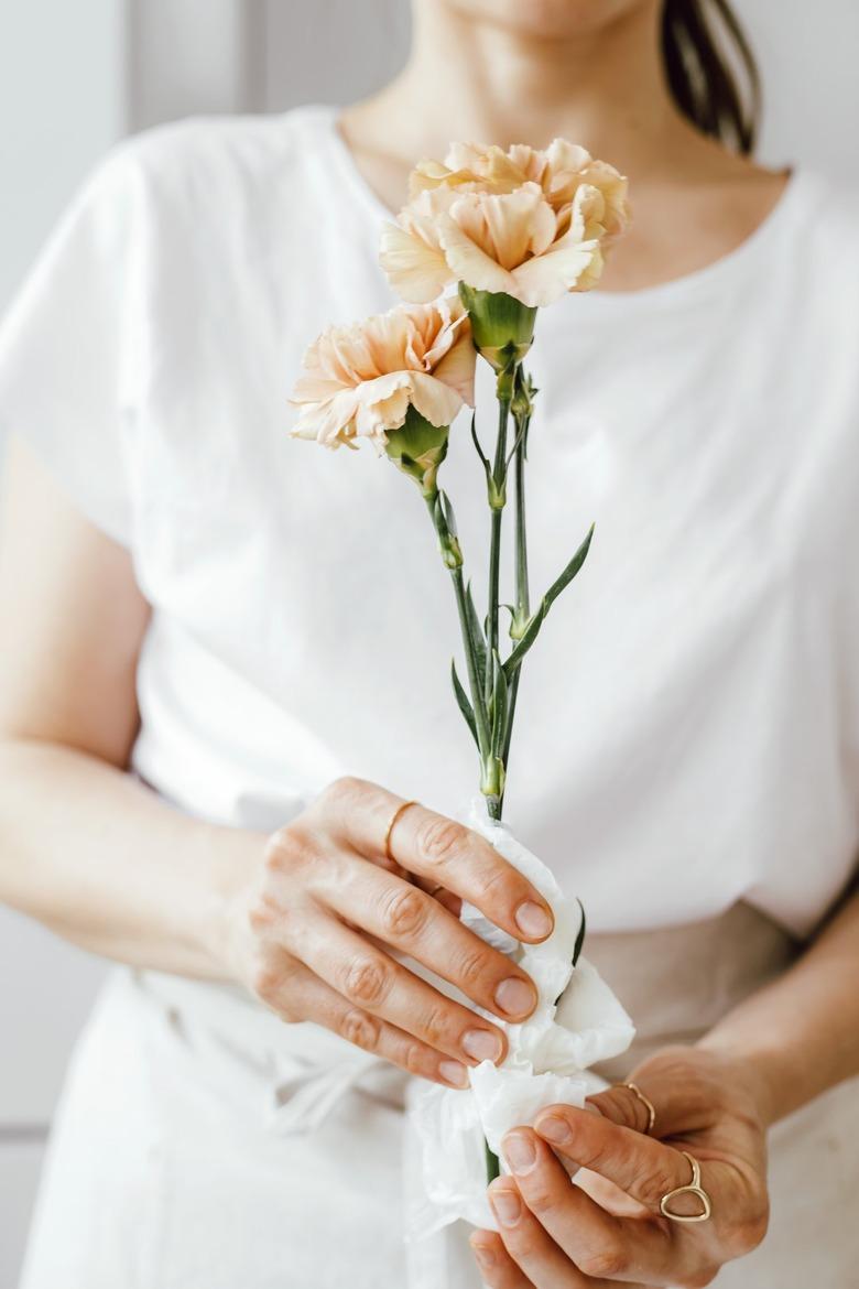 Choose hardy flowers that will last and wrap the ends in wet paper towel