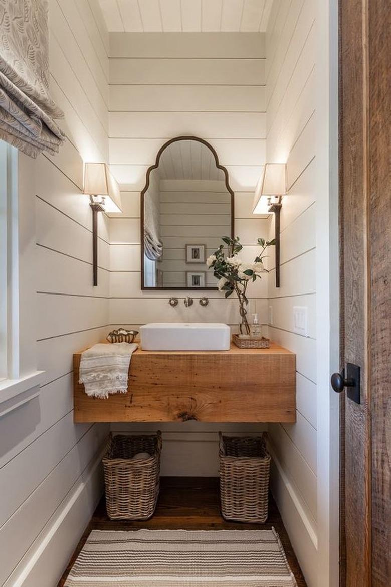 Power room with wood vanity, vessel sink, mirror, shiplap.