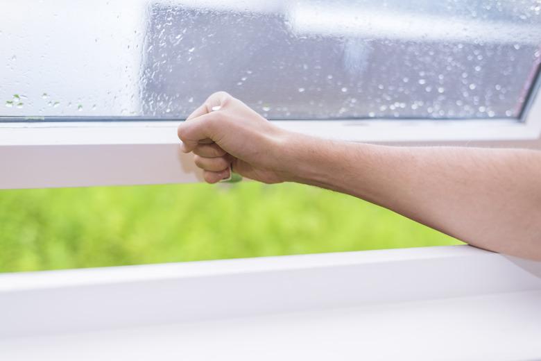 closing window with rainy weather outside