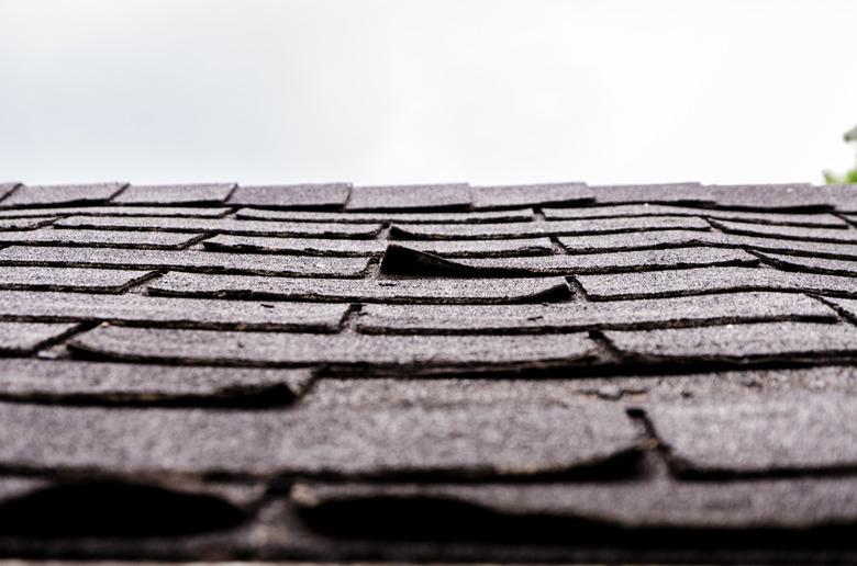 Close-up on damaged asphalt shingles