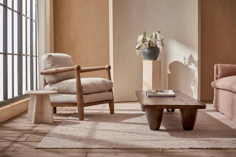 low-to-the-ground table next to cream chair