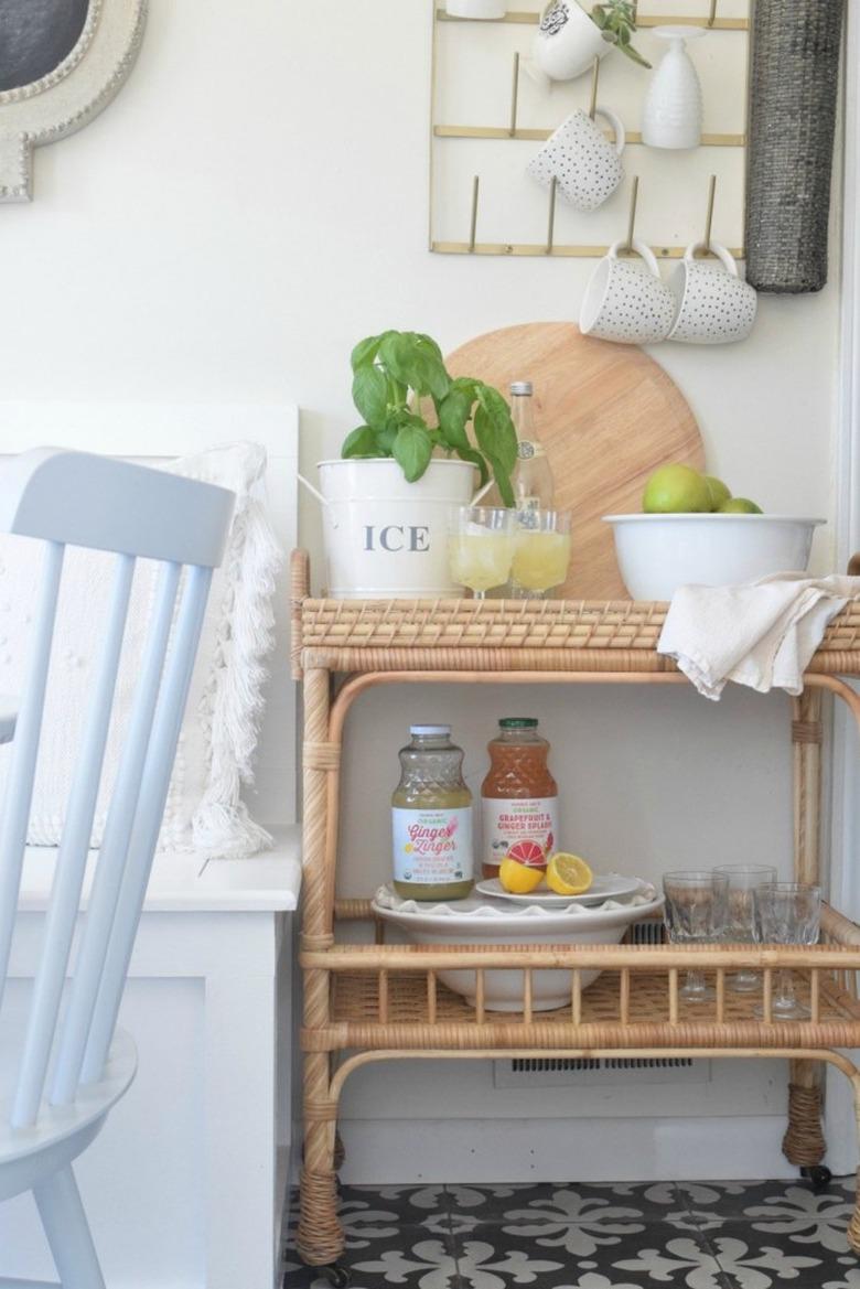 Farmhouse dining room storage idea with rattan cart