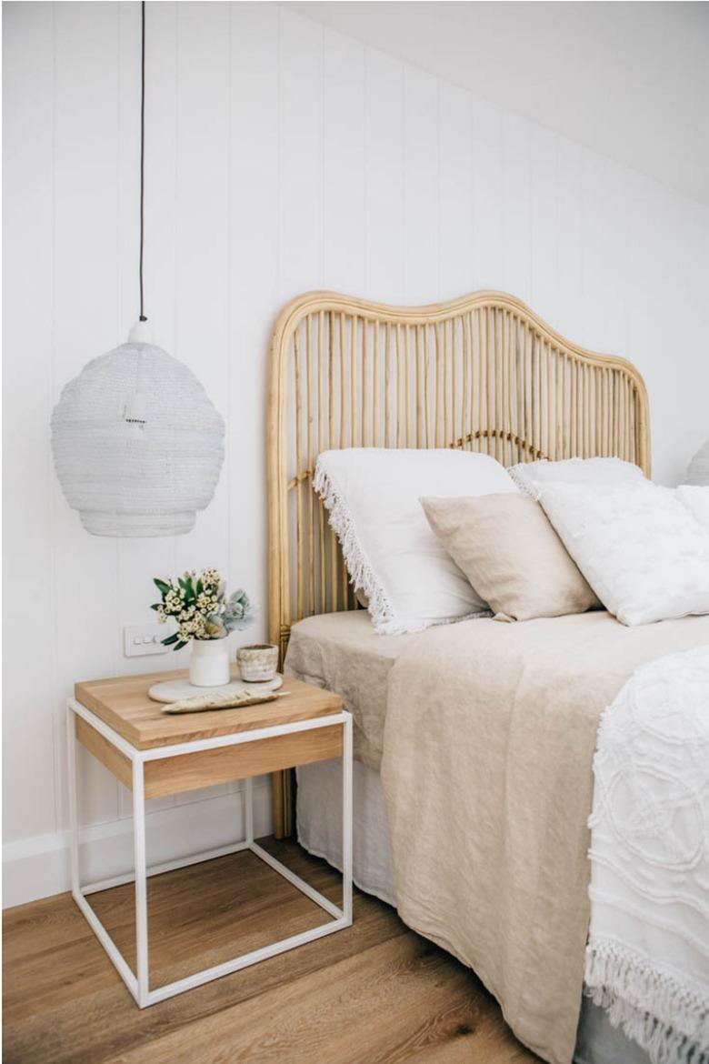 white minimalist bedroom with bamboo headboard