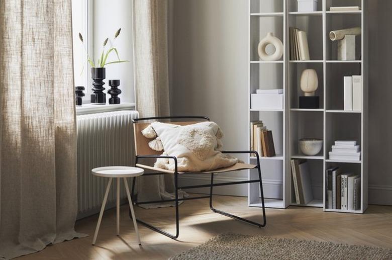 living room space with cane chair and bookshelves