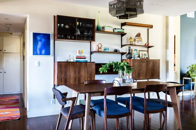 small spaces with A wood dining room set with blue cushioned chairs and a wood sideboard