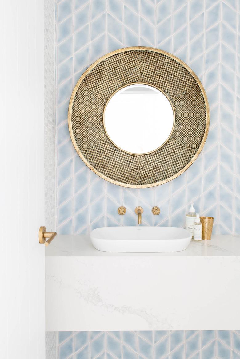 vessel bathroom sink on marble countertop with patterned wallpaper