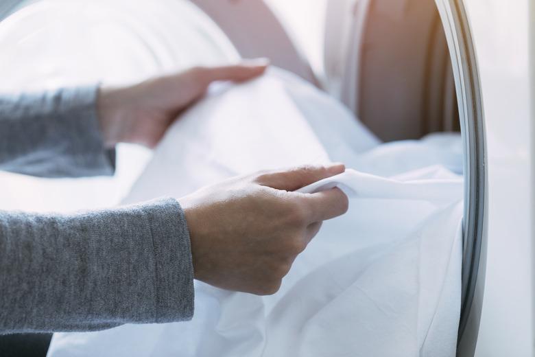 Checking for stains while unloading the washing machine.