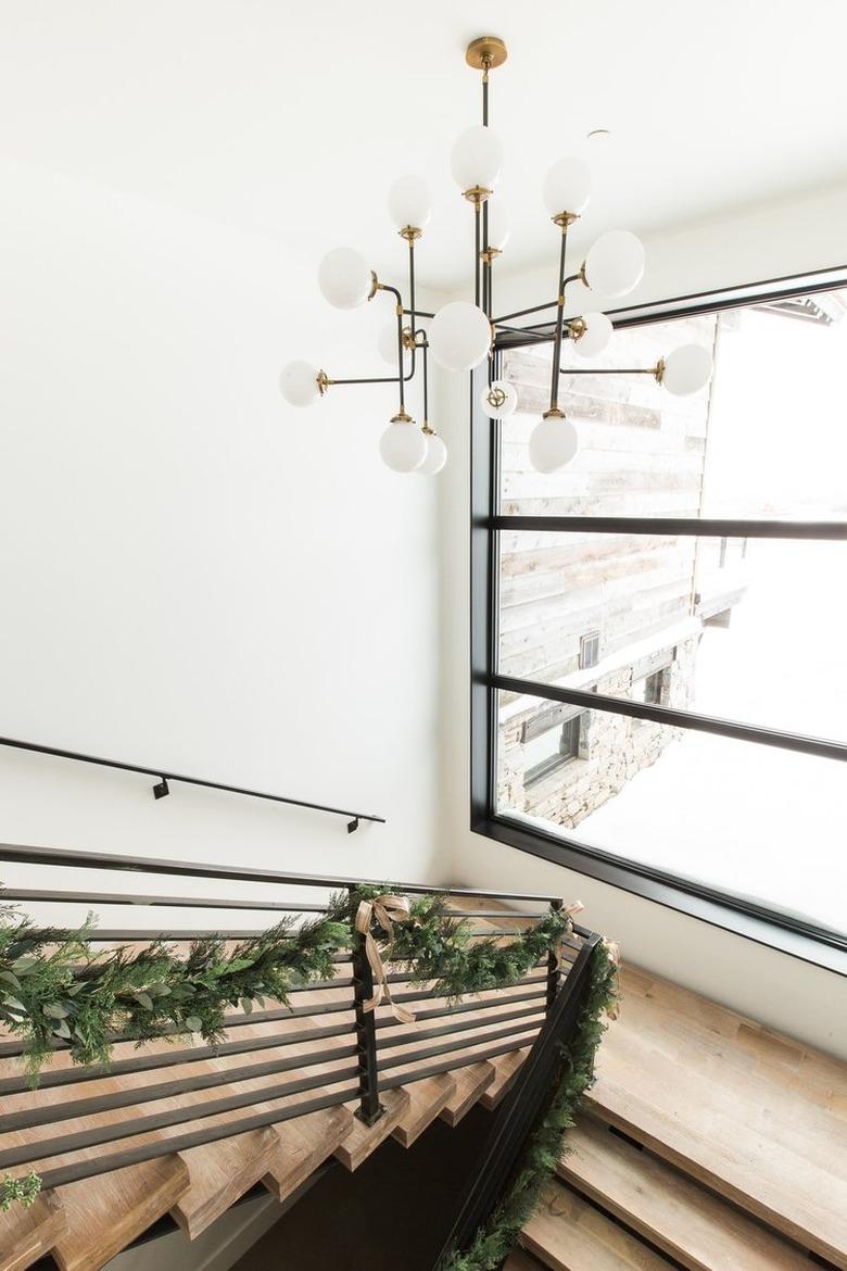 evergreen garland along modern mountain home staircase