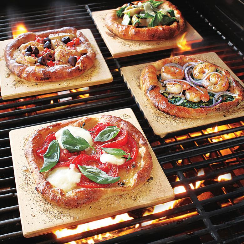 Mini pizza stones with pizzas inside oven. small stove size