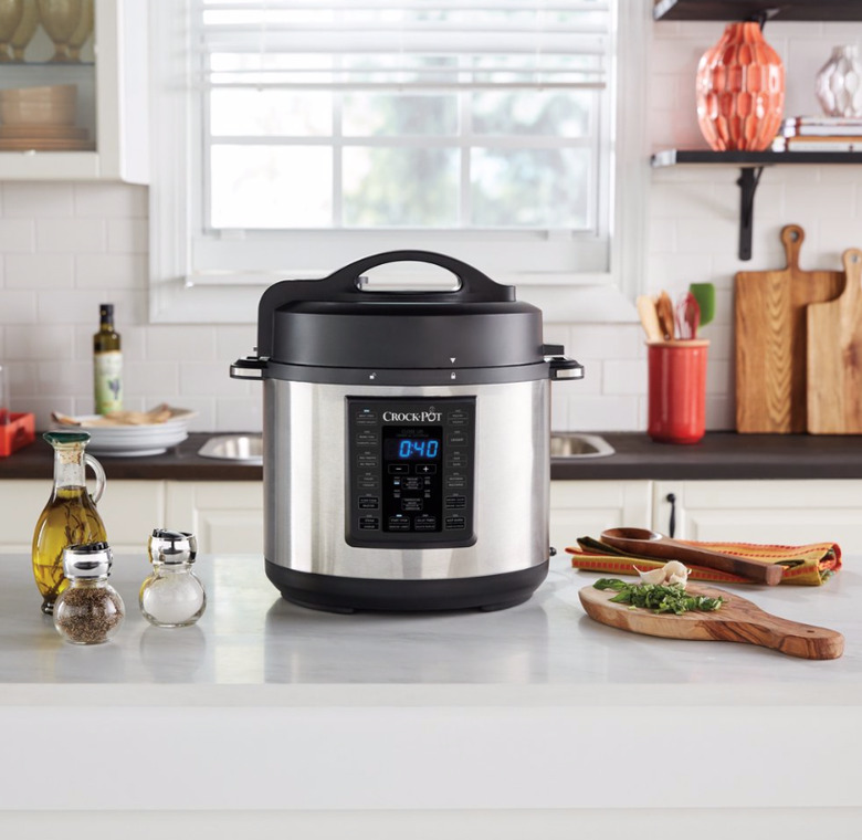 Slow cooker on kitchen counter with ingredients. small stove size ideas