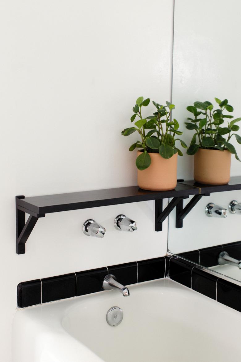 bathroom backsplash idea with black subway tile around white bathtub