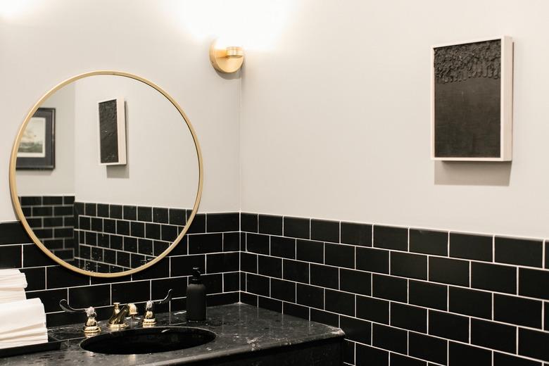 bathroom backsplash idea with black subway tile in modern bathroom