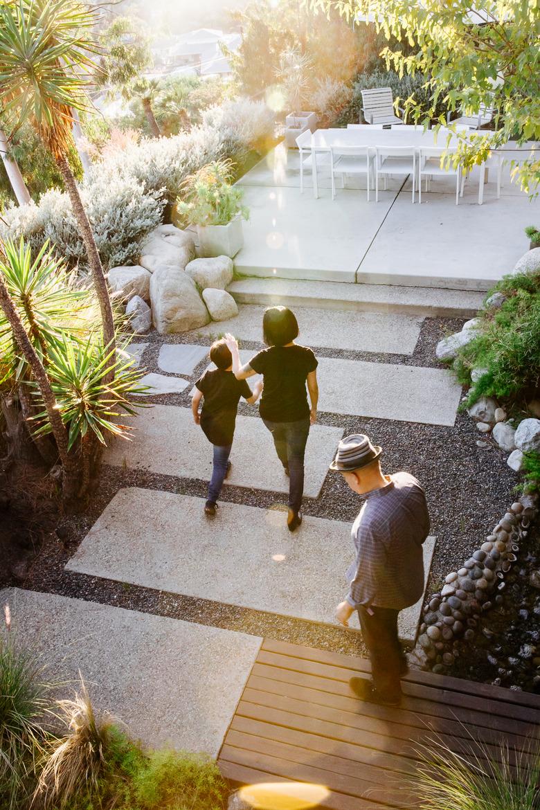 Family outdoors in beautiful garden with dining area