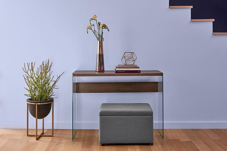 lavender wall with entryway furniture and plant