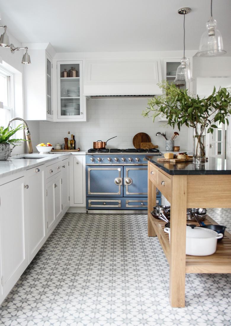 Kitchen floor tile idea with white cabinets and wood island