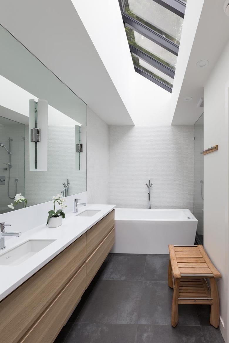 Modern white undermount bathroom sinks with solid surface countertop and wood vanity