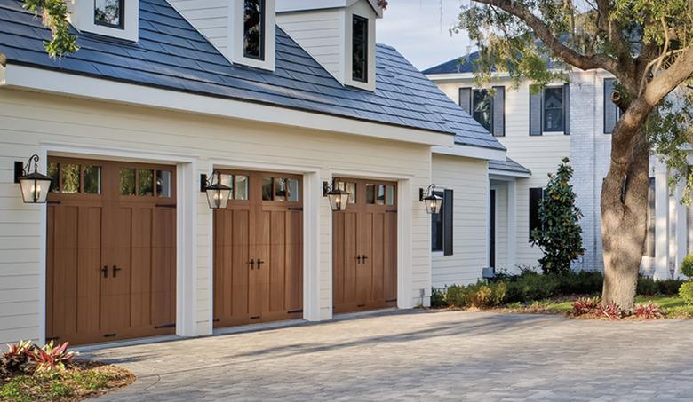 Sconces next to wooden Craftsman doors