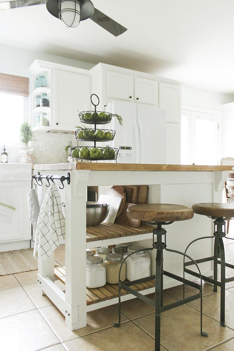 Farmhouse kitchen island storage with wood countertop