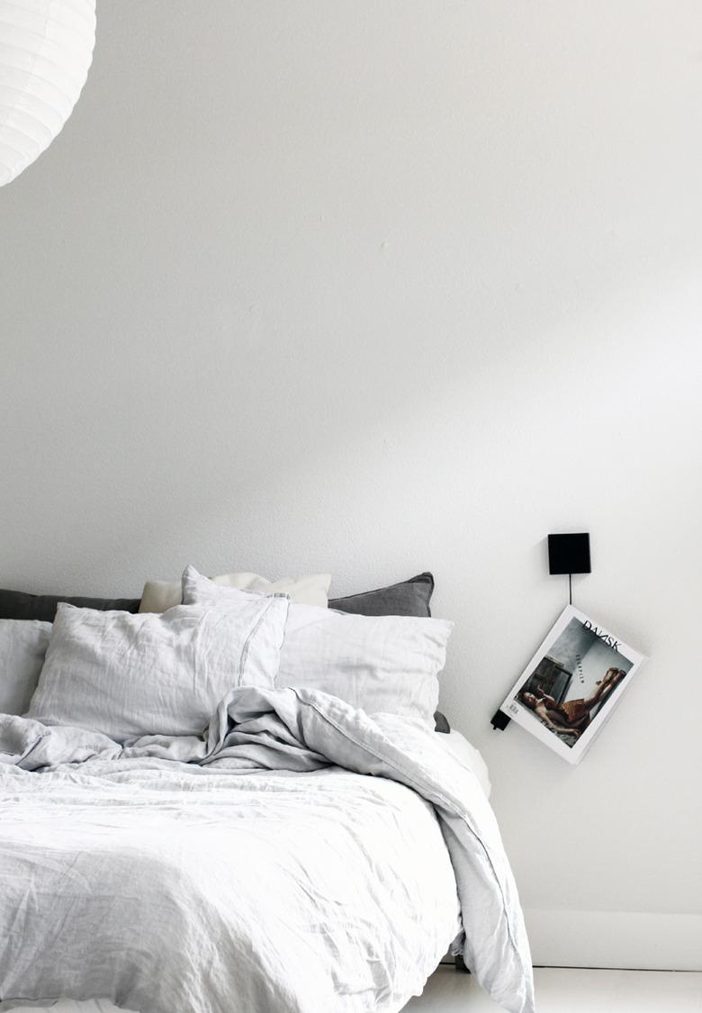 white minimalist bedroom idea with magazine hanger