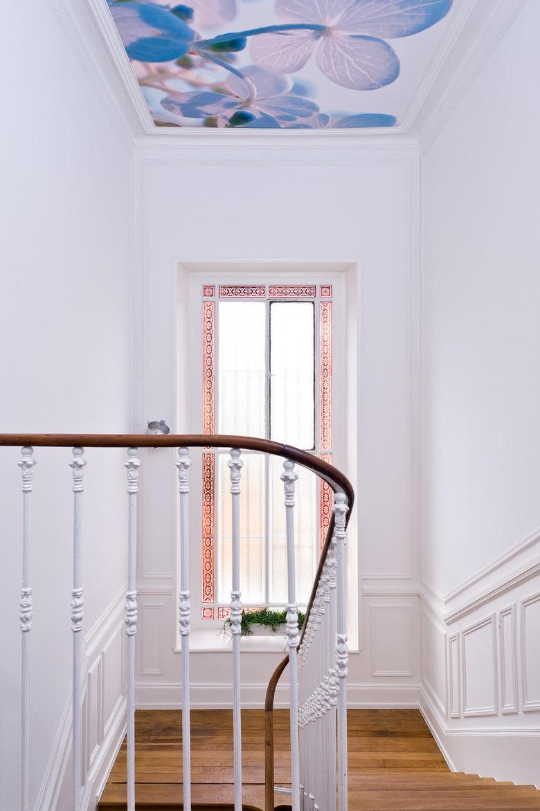 White hallway with pink and blue pastel ceiling