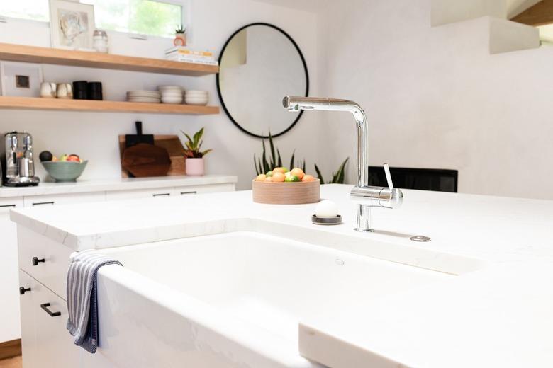 white apron sink in modern white kitchen