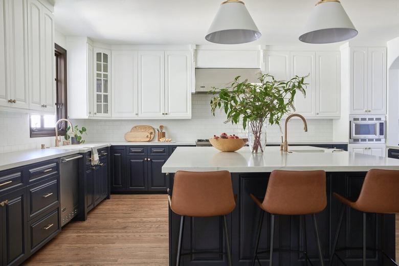 white upper kitchen cabinets and dark blue lower cabinets