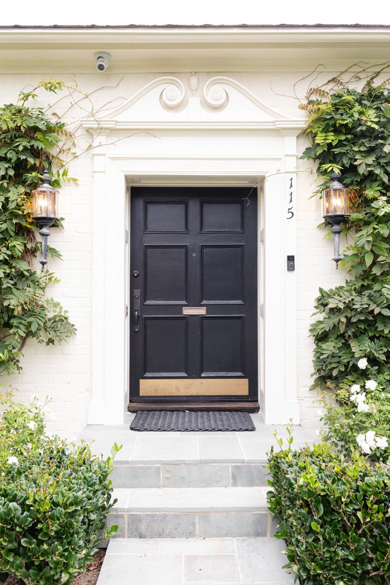 black traditional front doors with brass kick plate