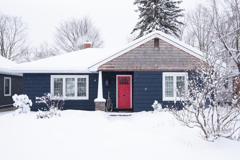 red traditional front doors on blue ranch style house