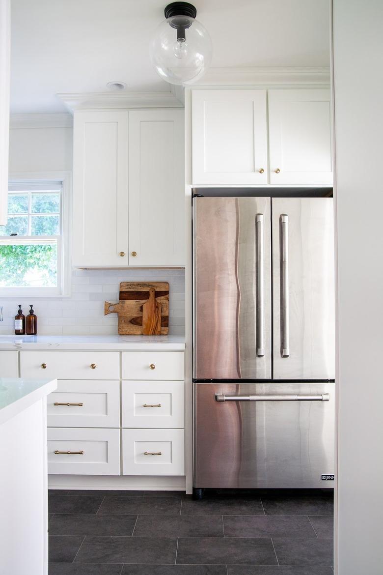 white traditional kitchen with cutting boards on countertop