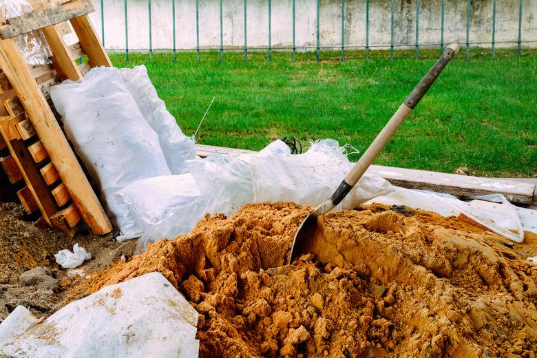 Soil with shovel, teel shovel be used for scoop sand to construct the building background, front view