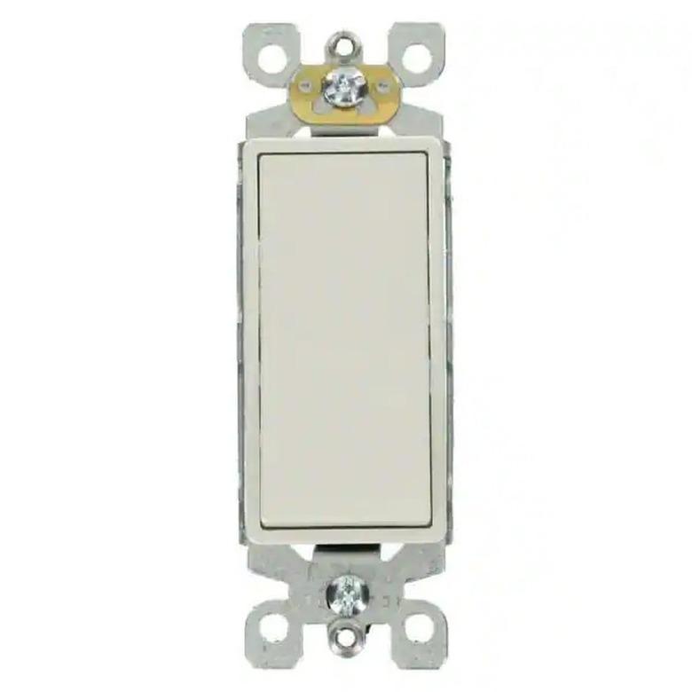 A white three-way light switch on a brighter white background.