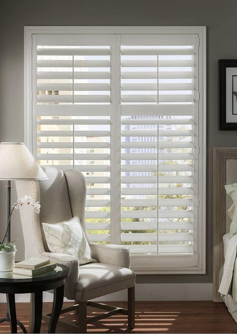 Interior louvered shutters in a bedroom