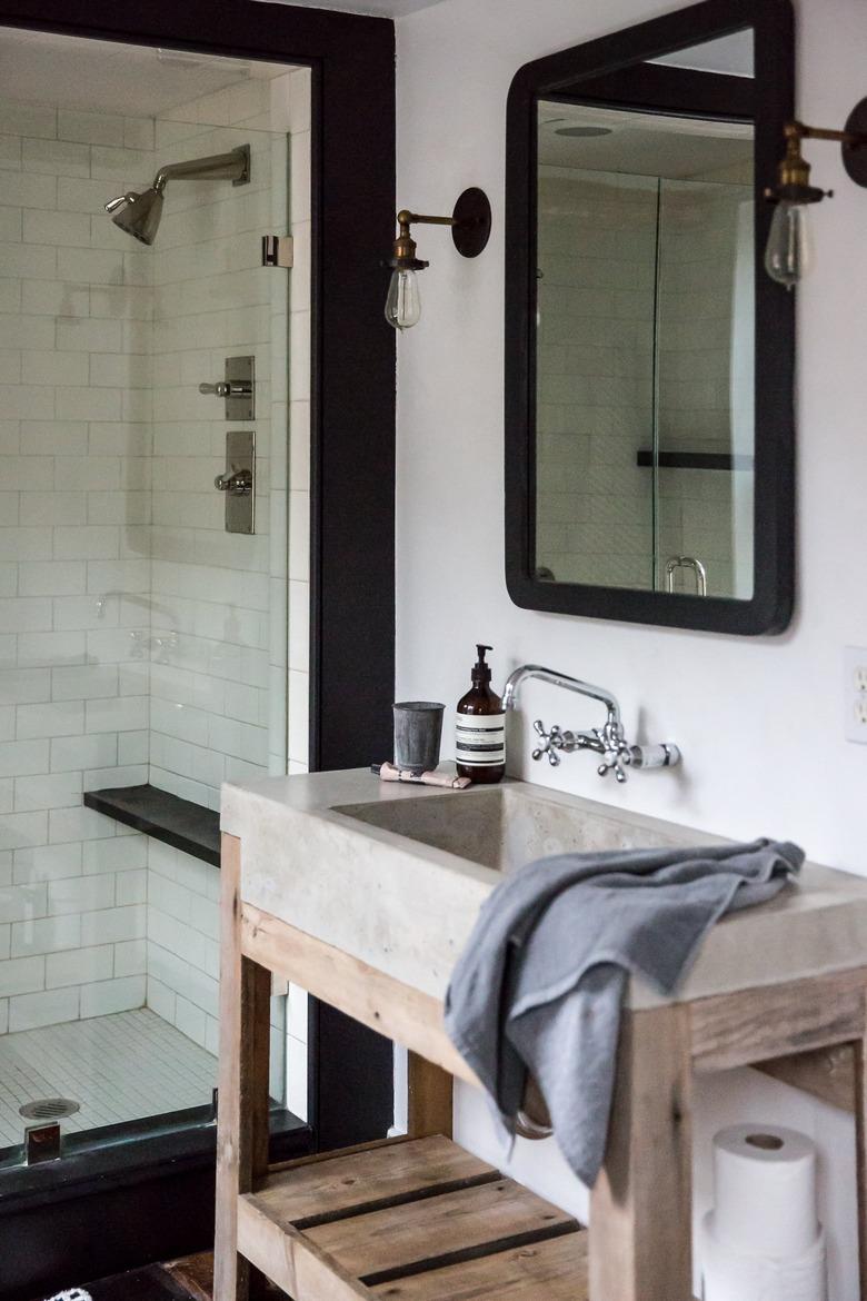 concrete bathroom sink on wood vanity in industrial bathroom