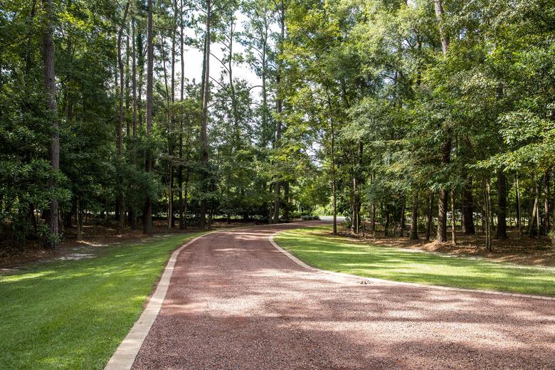 Long red gravel driveway.