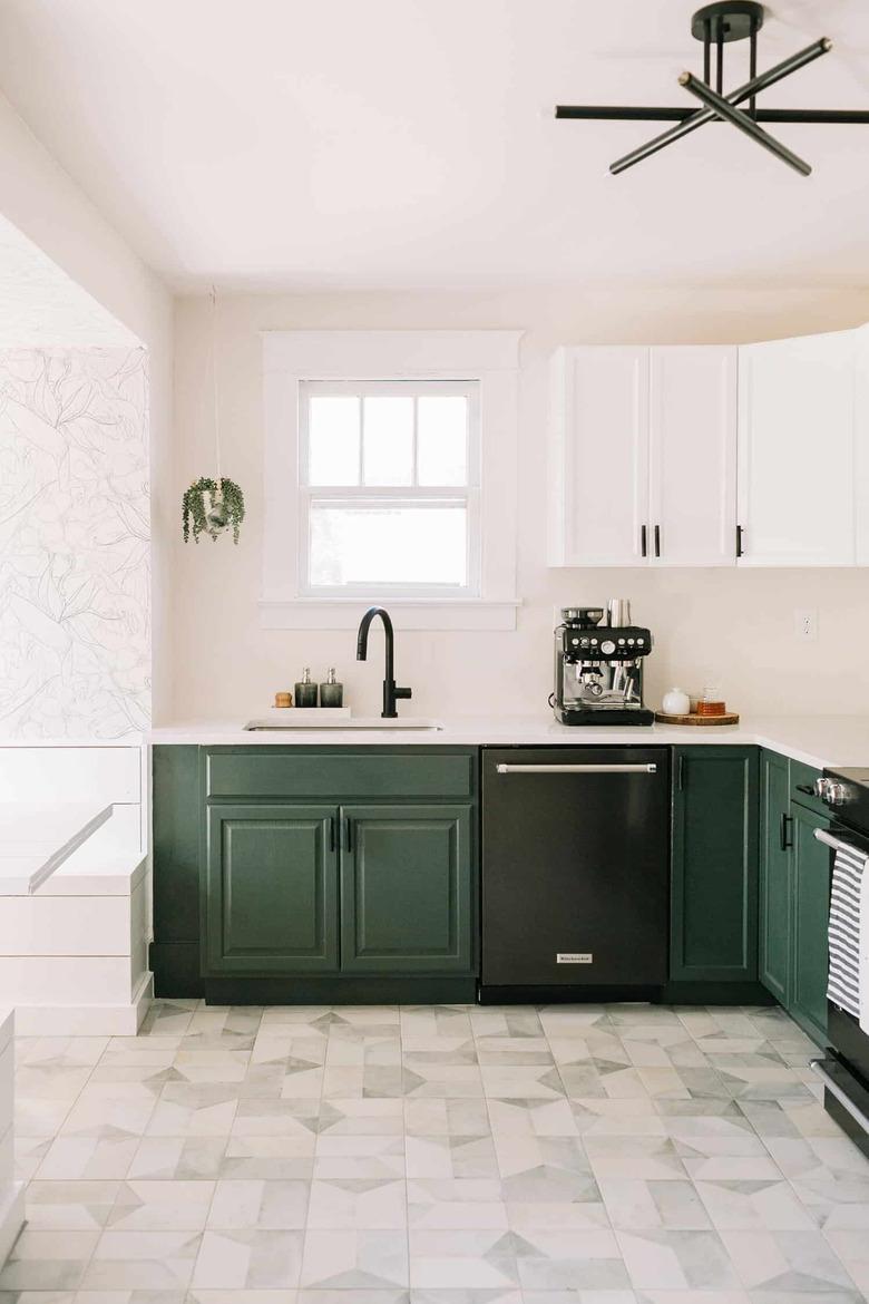 Craftsman kitchen with white and green cabinets and patterned flooing